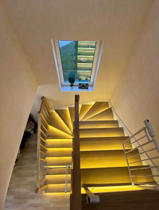 Отделка бетонной лестницы комбинацией цельноламельных ступеней из ясеня и мдф с балясинами из ясеня с подсветкой в Троице-Сельцо